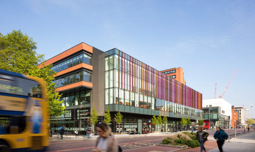 Alliance Manchester Business School building with shops below on Oxford Road, Manchester